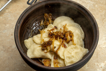 Ukrainian cuisine. vareniki with potatoes and fried pork fat and onions - cracklings. food concept
