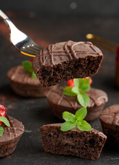 Freshly baked chocolate brownies decorated with sweet cherries and sprigs of mint