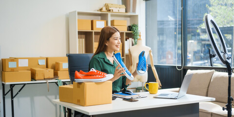 A beautiful Asian woman shares her journey of selling shoes via live camera on social media from...