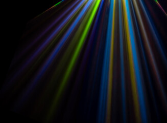 colored light beams from reflector through the foggy night sky