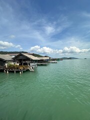 A boat is securely docked at a pier, situated in the vast ocean