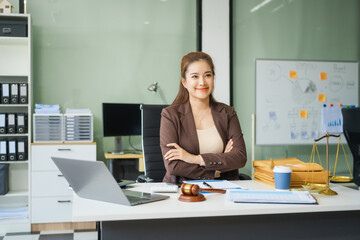 A young female lawyer sits at her desk in the office, providing online legal advice professionally....