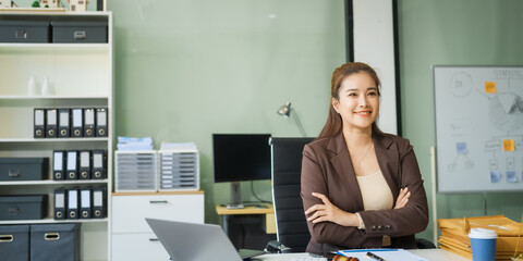 A young female lawyer sits at her desk in the office, providing online legal advice professionally....
