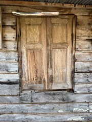 Closeup of a beautifully crafted wooden door on a wooden wall