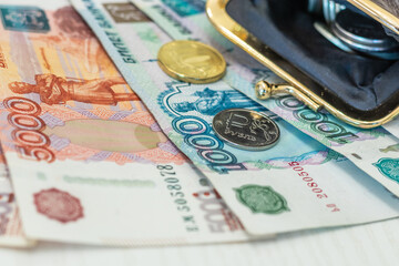 wallet with coins and banknotes on the table surface