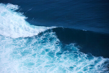 Blue and clean ocean crashing wave. Natural tropical oceanic water beauty.
