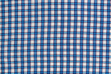 Checkered blue and white textile fabric background.