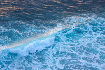 Fototapeta premium Blue and turquoise clean ocean crashing wave. Natural tropical oceanic water beauty in sunset light