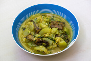 A bowl of cooked shing fish curry with gourd. Shing mach is a popular ingredient in Bangladeshi cuisine, prized for its health benefits, delicious taste, and nutritional value.
