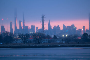 Fototapeta premium Stunning manhatta NYC skyline during sunrise winter season, far away skyline taken from New Jersy side, copy space travel world famous destination