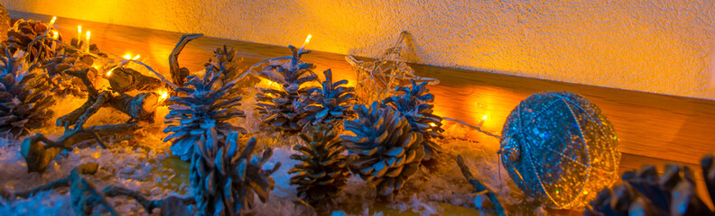 Christmas decorations illuminated by electric candles on an oak floor in a living room, Almere,...