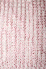 Fototapeta premium pastel pink knitting pattern, woolen yarn texture with braid design surface. Crocheted backdrop, abstract knitwear background