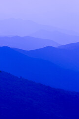 The mountains are blue and the sky is clear