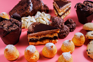 Table with various cookies, pound cake, cake slices, muffins and sweets.