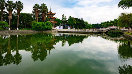 Buddhist temple with a bridge over the lake in Yunnan Province