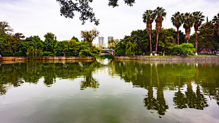 Buddhist temple with a bridge over the lake in South China, Yunnan Province