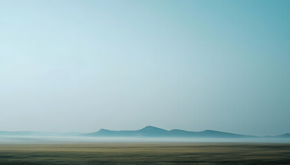 Obraz premium Misty Mountains Rise Above Serene Flatlands