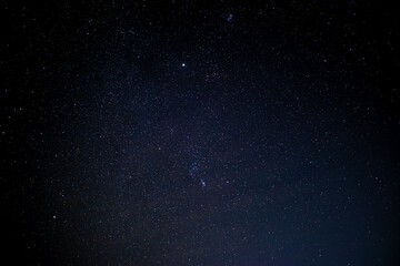 Obraz premium The sky is a vast expanse above us, home to countless stars that twinkle like distant beacons of light.