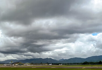 Naklejka premium Storm clouds over mountains, and Piarco Airport Trinidad