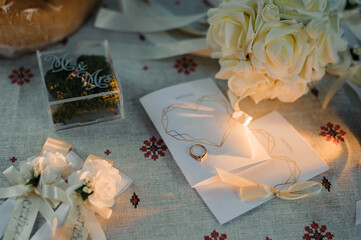 Elegant Wedding Details with Floral Arrangements and Ring