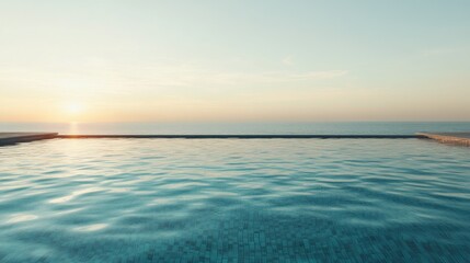 Fototapeta premium Serene morning view of an infinity swimming pool overlooking the tranquil sea at sunrise with clear blue skies and gentle waves.