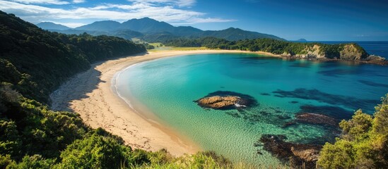 Fototapeta premium Serene coastal landscape showcasing pristine beaches and lush natural surroundings with mountains in the background at sunrise or sunset.