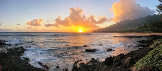 Obraz premium Breathtaking sunset over the ocean with vibrant colors reflecting on the water and dramatic clouds creating a serene coastal landscape.