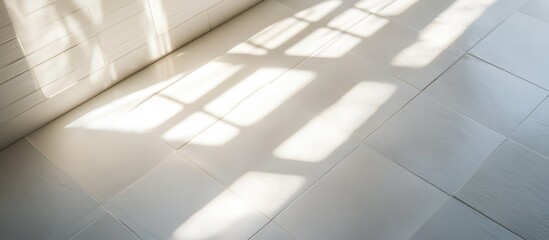 Obraz premium Elegant white wall tiles on a floor with natural light creating shadow patterns enhancing interior design aesthetics and inspiration.