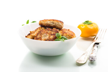 fried chicken cutlets in a bowl, isolated on white background