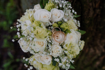 Elegant Wedding Bouquet with White Roses and Gold Rings
