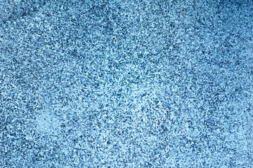 textured blue surface with speckled pattern, creating calming and serene atmosphere. This evokes feelings of tranquility and coolness, perfect for various design projects