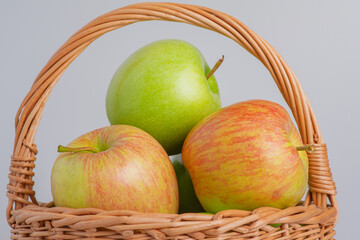 Apples on a gray background in a basket. Apple, fruit.