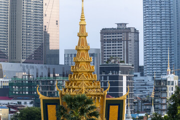 The throne hall inside the Royal Palace complex and the new skyscrapers in Phnom Penh, Cambodia