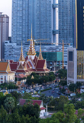 The throne hall inside the Royal Palace complex and the new skyscrapers in Phnom Penh, Cambodia