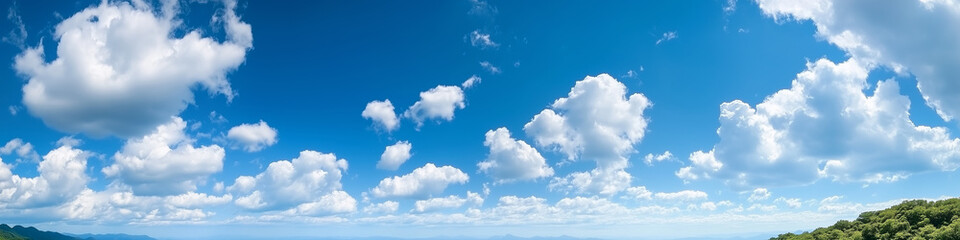 Obraz premium Wide panoramic view of blue sky with scattered white clouds in a clear, bright atmosphere, perfect for outdoor and travel-related themes.
