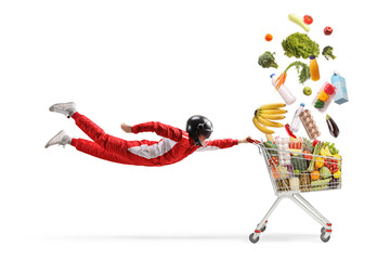 Car racer in a red suit flying and holding a shopping cart with falling groceries © Ljupco Smokovski
