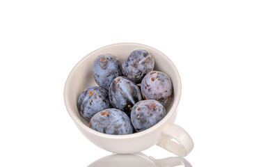 Black ripe plums with home accessories isolated on white background, close-up.