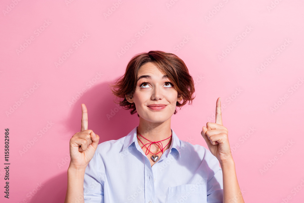 Poster portrait of gorgeous lady look direct fingers up empty space proposition isolated on pink color back