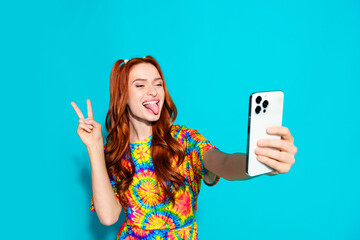 Photo of attractive young woman selfie photo v-sign stick tongue out dressed stylish colorful clothes isolated on cyan color background