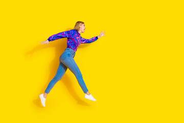 Full body photo of attractive young woman running black friday dressed stylish colorful blue clothes isolated on yellow color background