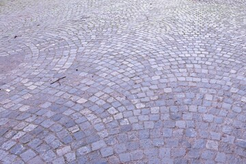 Cobblestone pavement forming concentric arcs in urban setting