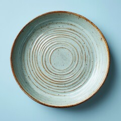 Top view of a rustic teal ceramic bowl with concentric circles.