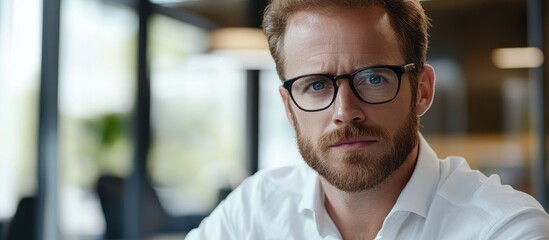 Focused business professional analyzing financial data for strategic investment decisions in a modern office setting with empty space for text.