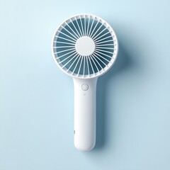 White handheld mini fan on blue background.