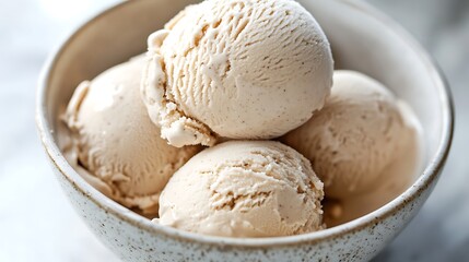 Fototapeta premium Design a close-up image of a bowl filled with almond milk ice cream scoops