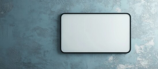 Elegant black framed rectangular mirror on textured blue wall with ample empty copyspace for customizable text or messages