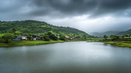 Obraz premium Serene Lake in the Monsoon: Picturesque landscape of a calm lake nestled amidst lush green hills under a dramatic monsoon sky. The scene evokes tranquility and the beauty of nature's elements. 