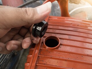 Activity of checking the pump engine oil by opening the oil cap