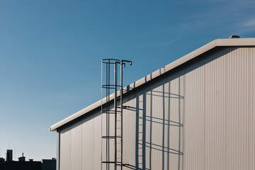 Industrial Ladder and Shadows on Modern Building