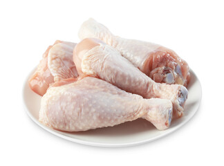 Raw chicken drumsticks on plate against white background
